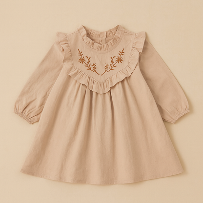 Beige dress with floral embroidery on a beige background